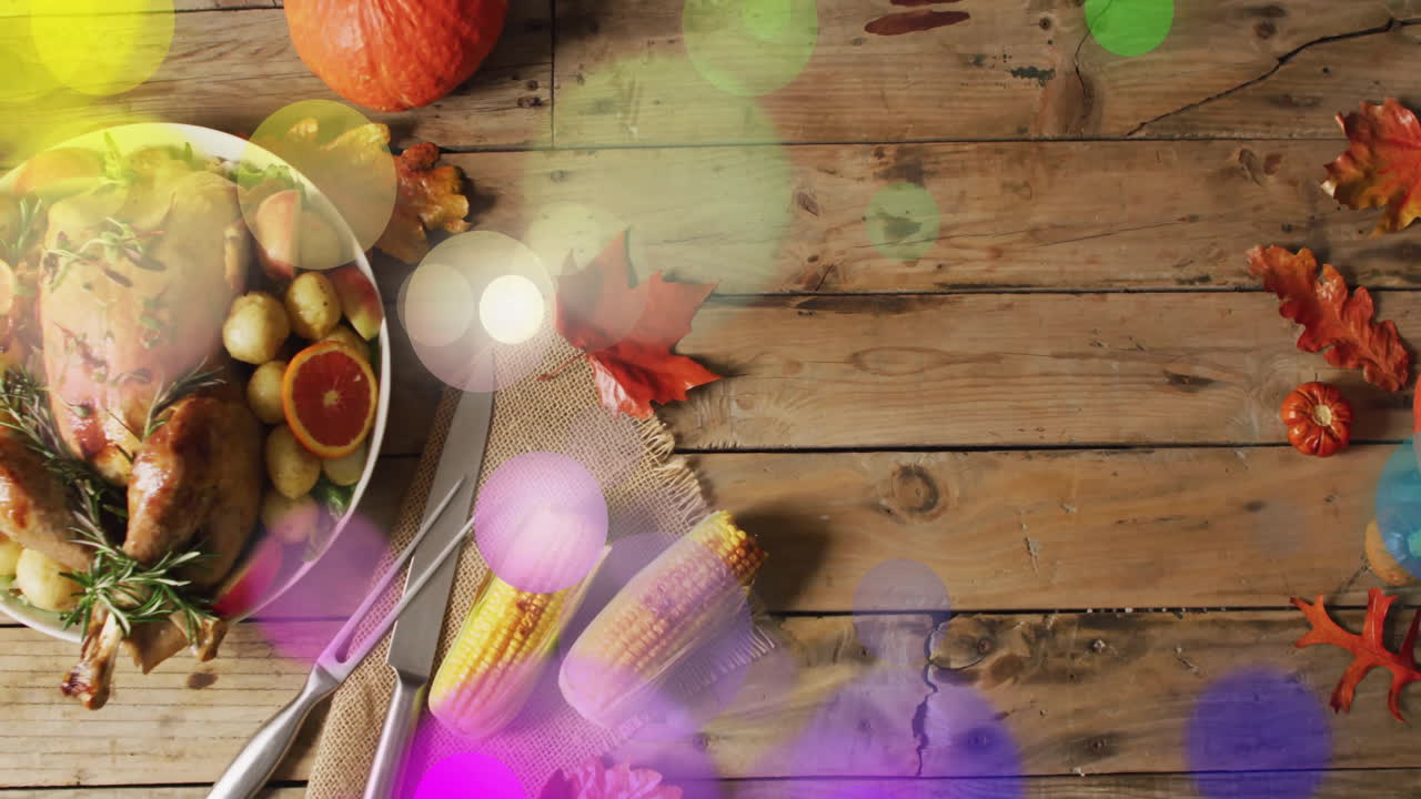 Thanksgiving dinner with turkey, corn, and autumn leaves decorating wooden table