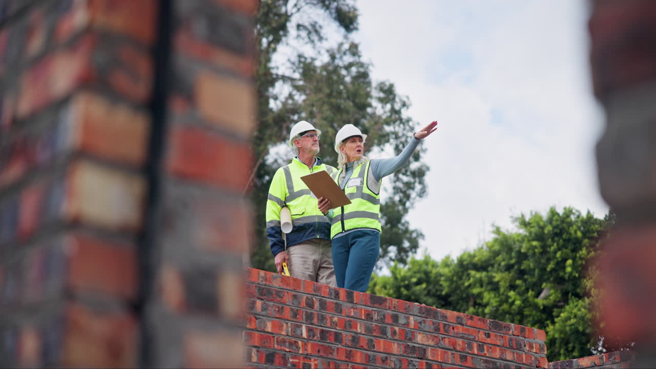 Construction Workers Inspecting a Brick Wall