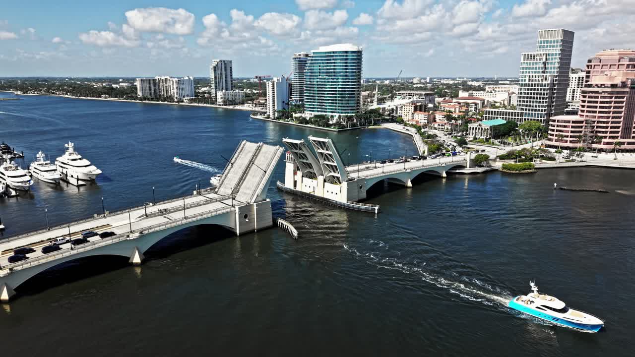 Pull out drone shot of Royal Park Bridge open, One Flagler and Phillips Point building during the day in West Palm Beach, Florida, USA
