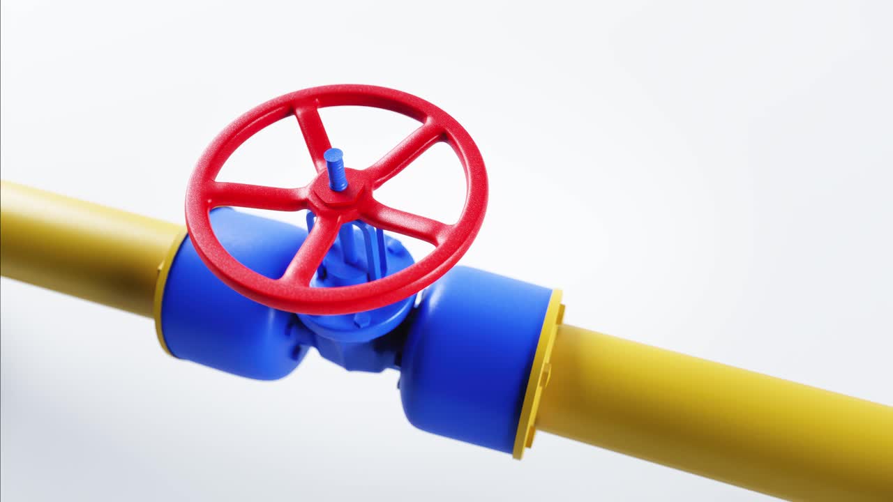 Valvola a volantino rossa su un tubo del gas giallo che gira