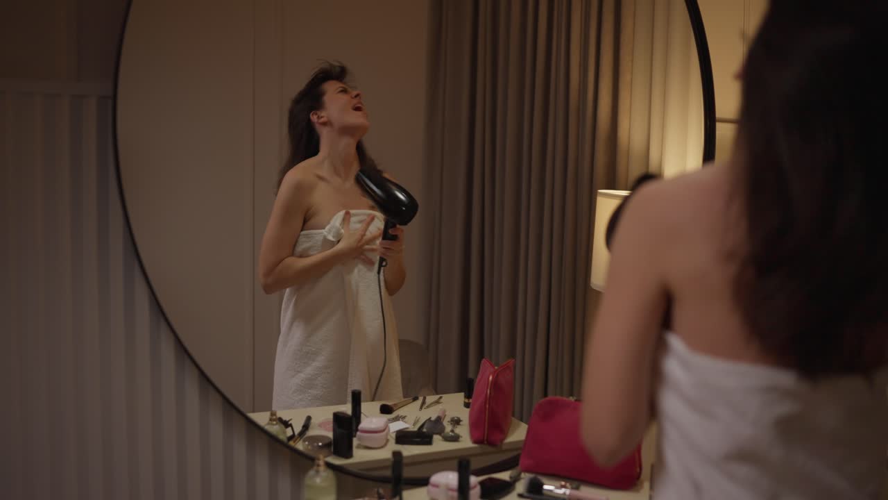 Woman Drying Hair in Mirror Reflection