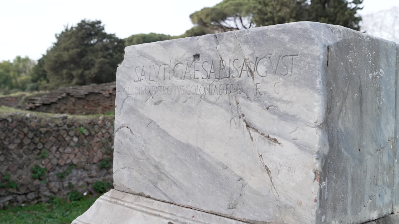 An ancient Roman inscribed granite pillar at the seaport historic site of Ostia Antica.