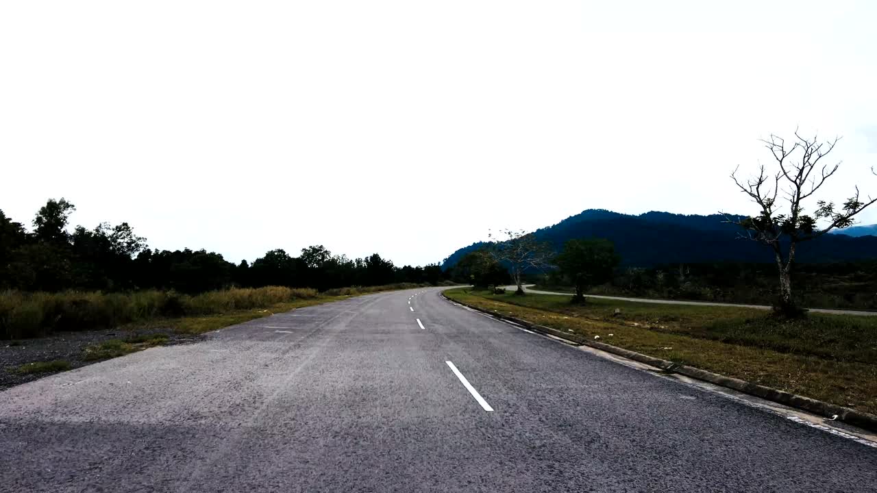 Beautiful View Drive Along Sempadi Lundu Coastal Road with Green Forest and Mountain,Sarawak,Borneo.