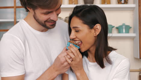 couple sharing a cupcake in the kitchen