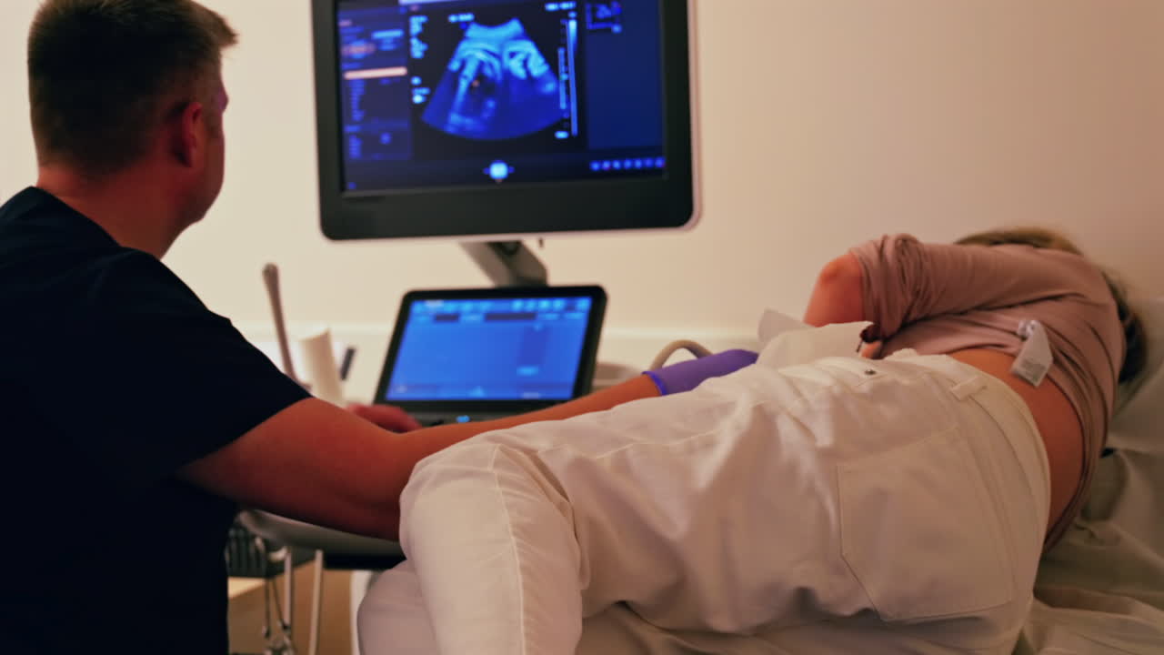 Pregnant woman undergoing an ultrasonography at a doctor's office