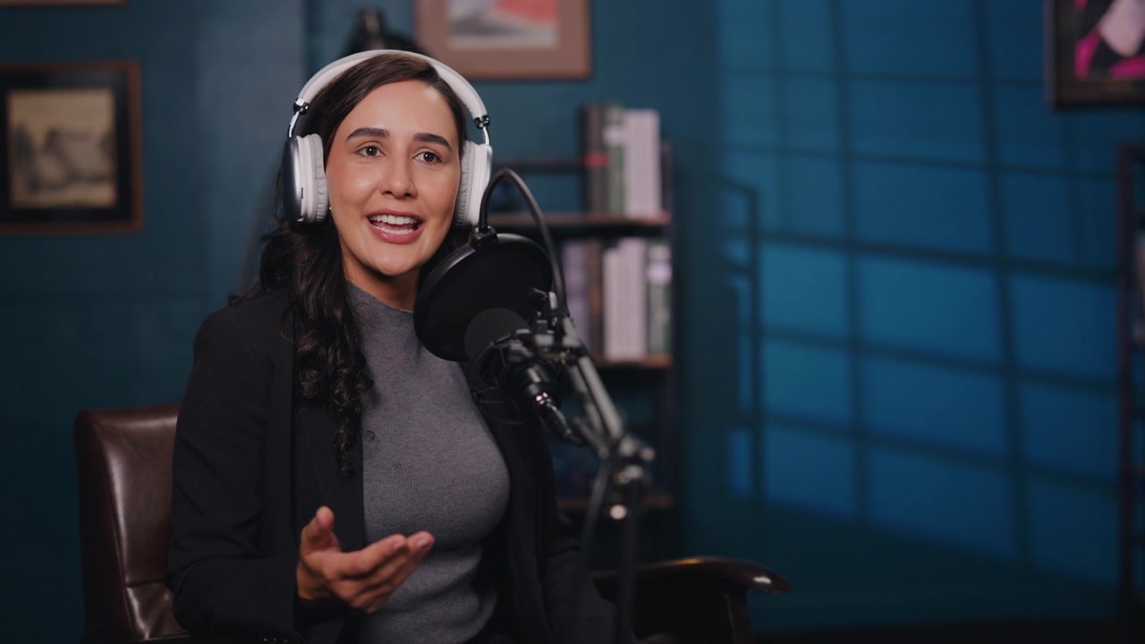 Young Woman Putting On Headphones and Recording a Podcast in Studio