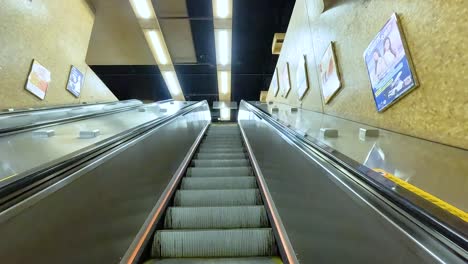 ascending escalator in a busy hong kong station