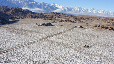 Scenic-drive-in-Alabama-Hills-and-East-Sierra-Nevada-landscape-snow-covered-in-Lone-Pine,-Owens-Valley,-California