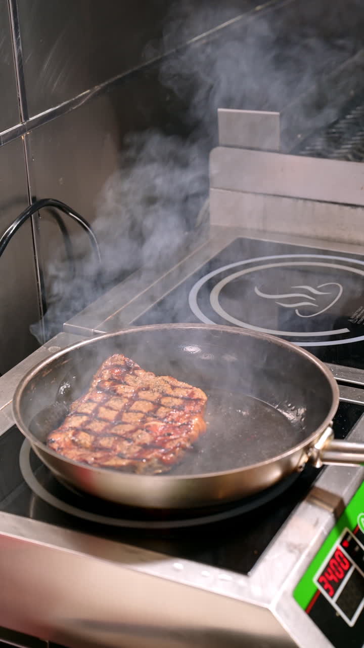 Grilled steak frying in pan. Juicy grilled steak cooking in frying pan with smoke rising