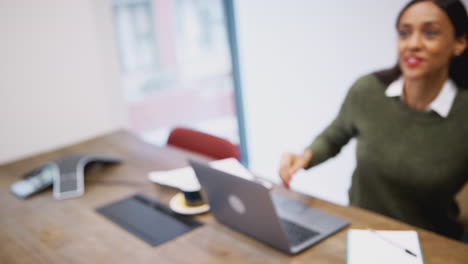 Businesswoman-Shaking-Hands-With-Male-Job-Candidate-In-Meeting-Room-Before-Interview