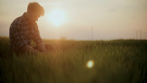 Young-Farmer-Amidst-Grass-In-Farm