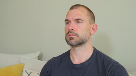 Close-up-Portrait-Of-A-Man-Focused-And-Contemplating-At-Home