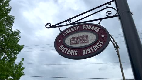 a street sign hanging over liberty square historic district in clay county also home to liberty jail a mormon visitor center in liberty missouri