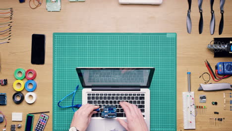 Coding a project on a laptop with electronic components