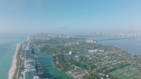 Aerial-panoramic-footage-of-large-city-on-sea-side.-Downtown-high-rise-office-buildings-in-distance.-Miami,-USA