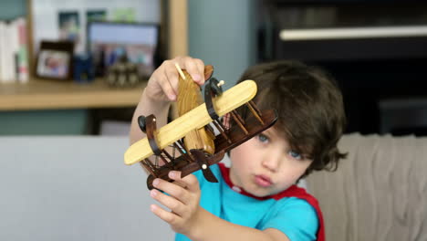 boy playing with a toy plane