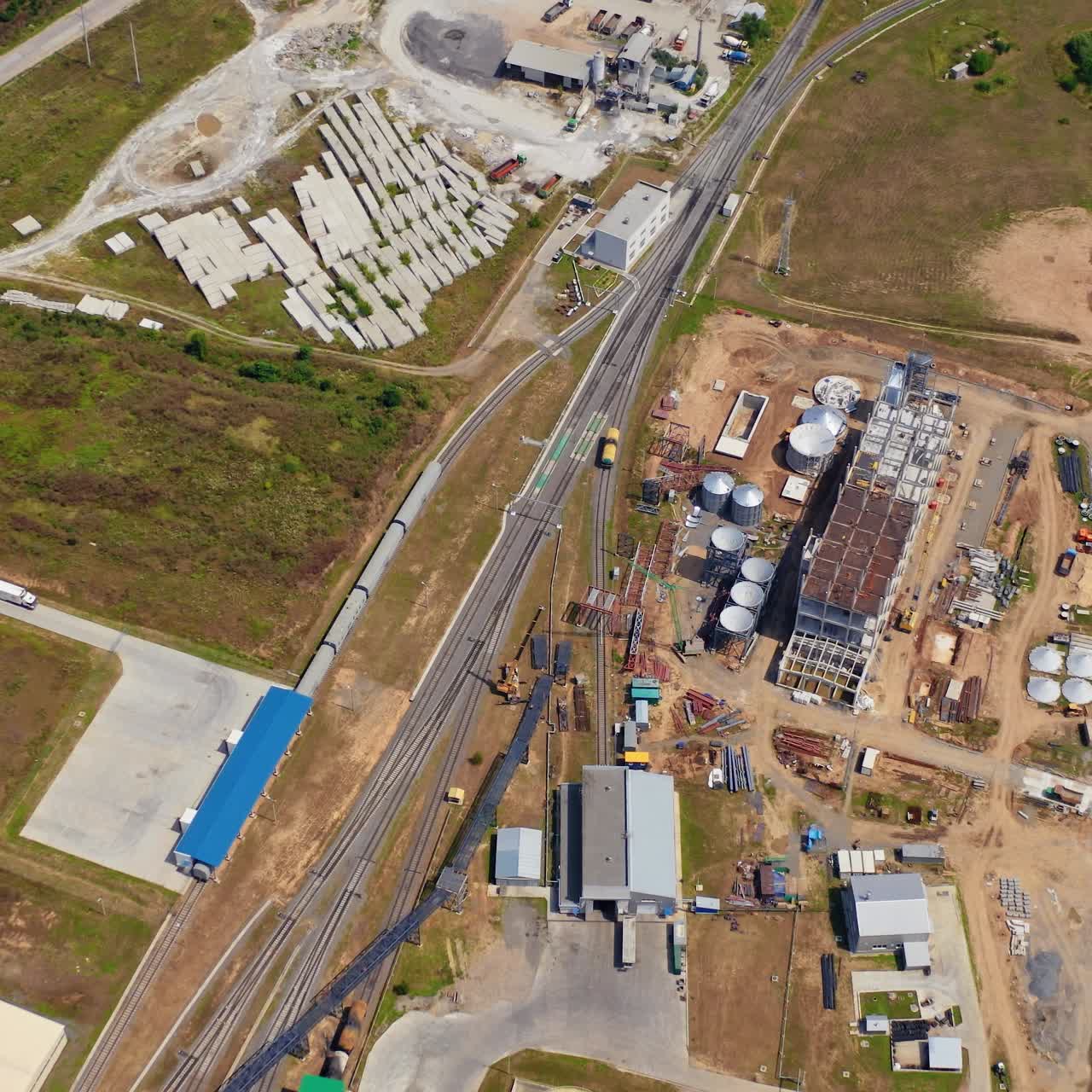 Construction of new granary on field. Abandoned industrial territory. Building new grain elevators. Aerial view