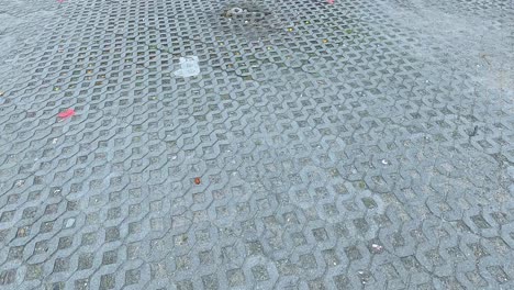 a sequence showing a textured brick floor in koh samui, thailand, with subtle lighting changes and scattered debris