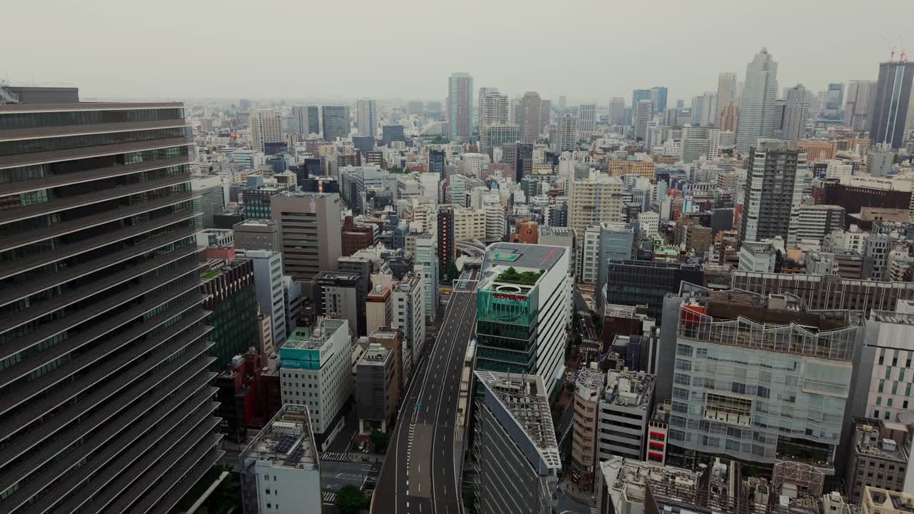 Aerial view of a cityscape with modern architecture and a road