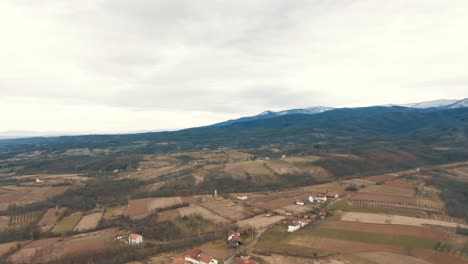 Autumn-landscape-of-the-village-and-arable-land-and-forest,-Drone-4K-cplored