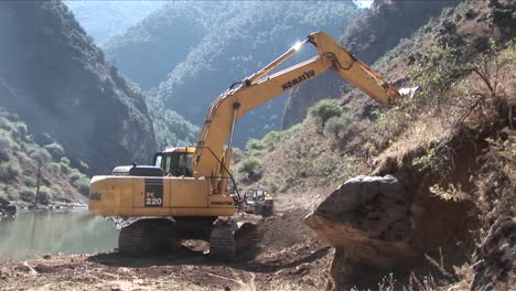 A-steam-shovel-moves-earth-along-a-rural-road