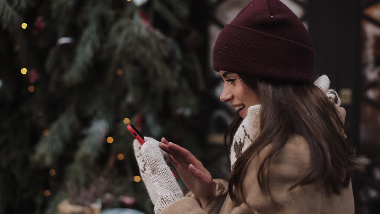Woman using phone outdoors in winter