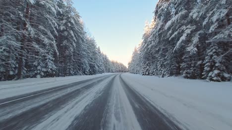 speeding winter driving pov snowy icy roads with forest scenery finland