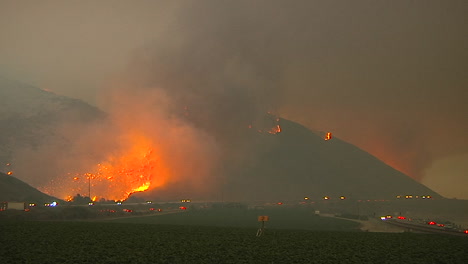 the thomas fire burns at night in the hills above the 101 freeway near ventura and santa barbara california 1