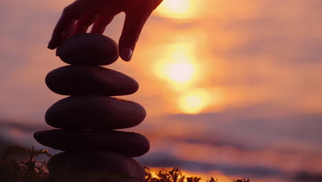 carefully and intently build a pebble tower accuracy and balance concept