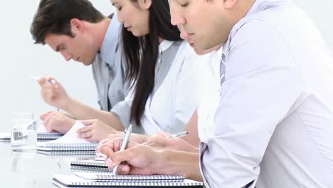 attentive business team writing notes