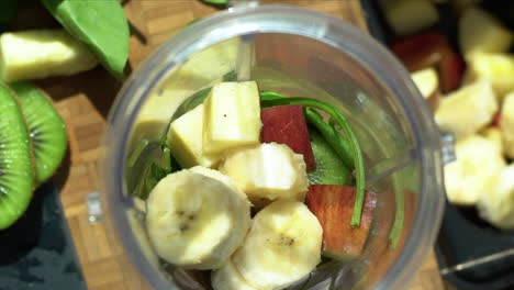 Close-Up-of-Female-Hands-Placing-Sliced-Banana-In-Blender