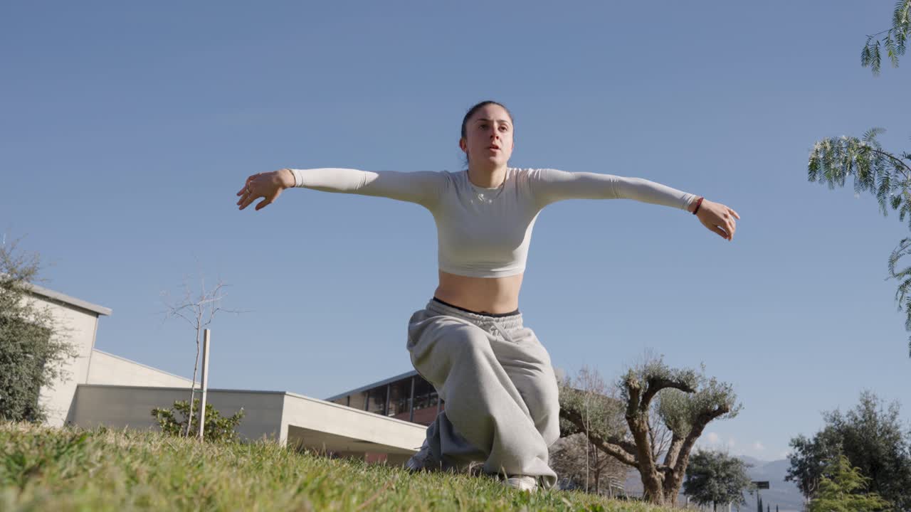 Young woman performing acrobatics in parkour style
