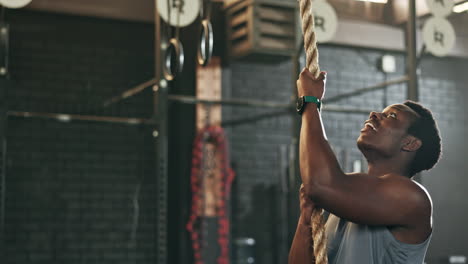 Fitness,-gym-and-black-man-climbing-rope