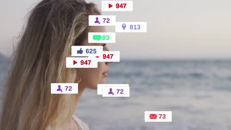 Animation-Von-Social-Media-Symbolen-Auf-Bannern-über-Einer-Entspannten-Kaukasischen-Frau,-Die-Die-Aussicht-Am-Meer-Bewundert