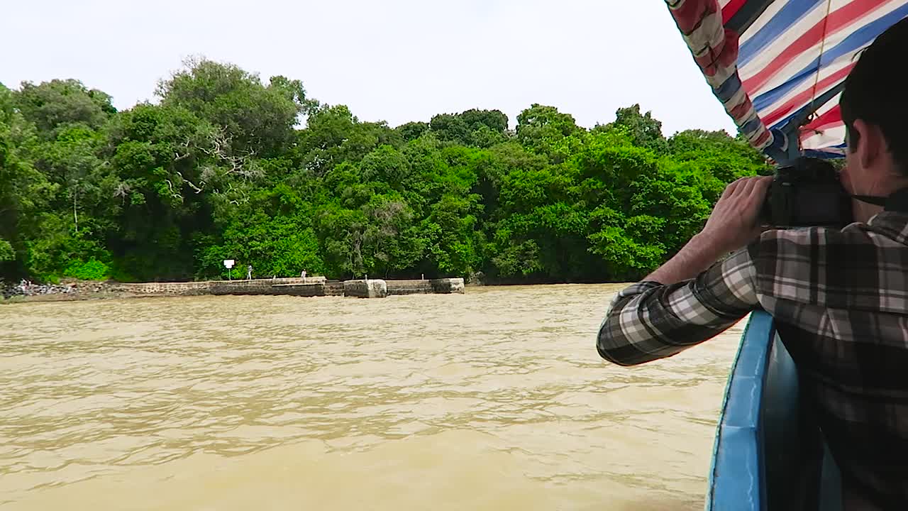 Man with camera in a boat in Tana lake, Ethiopia.