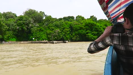man with camera in a boat in tana lake, ethiopia.