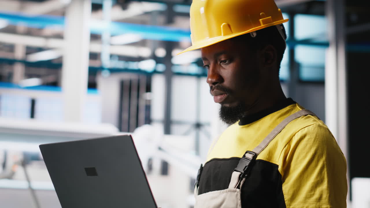 Vertical Video Male engineer in solar panel factory reviews photovoltaic system performance