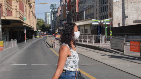 woman wearing mask during covid19 crossing flinders st