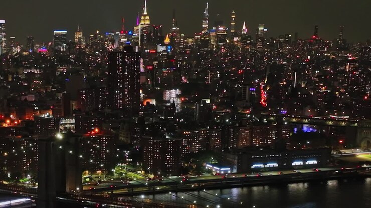 Nighttime aerial view of New York City showcasing lights and skyline