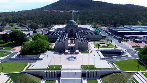 drone aerial landscape of war memorial museum building with front entrance stairs and crane development construction canberra city capital act australia travel tourism anzac parade