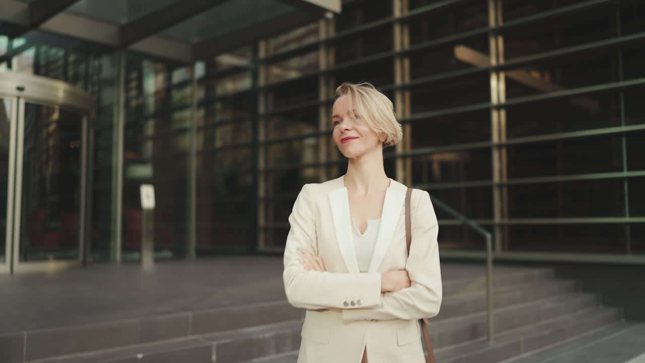 Confident businesswoman in front of modern office building