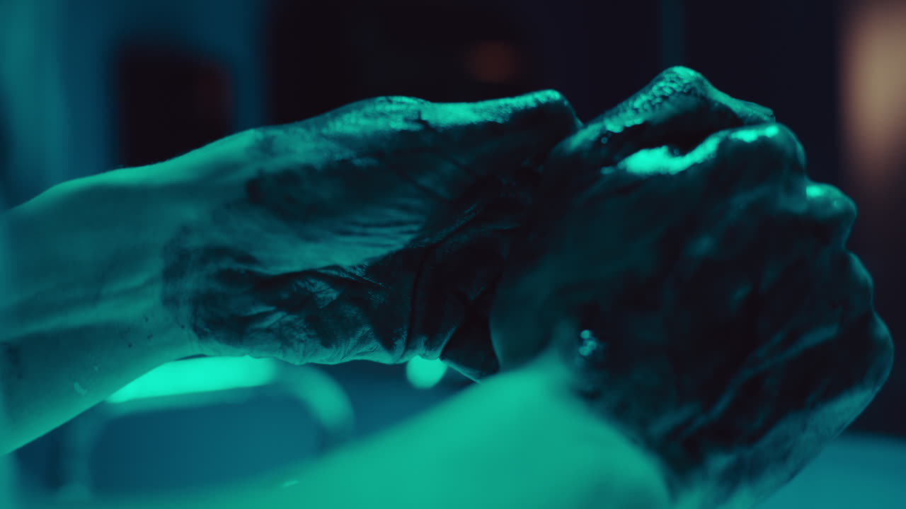 Close-up of hands with dark paint