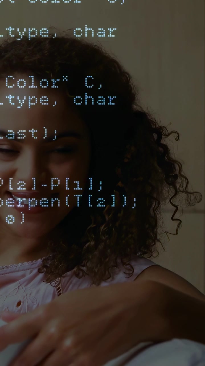 Vertical video: Woman looking down at tablet starting code overlay scrolling over face showing tech