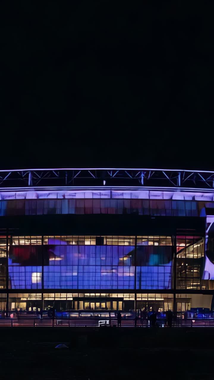 Vertical video: Initiating LED lighting shifting arena facade into tricolor tones for night display
