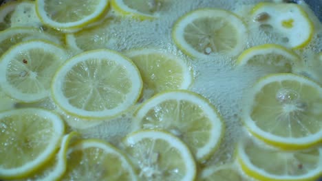 pov to the lemon sliced in boiling sugar for making lemonade