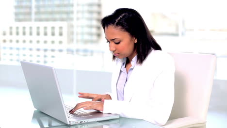 Gorgeous-dark-haired-businesswoman-working-with-her-notebook