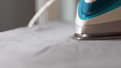 view of a steam iron sliding across the fabric