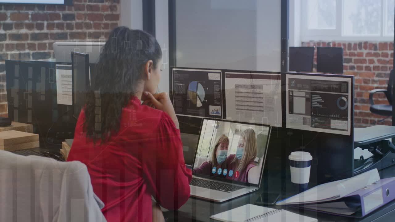 Animation of data processing over rear view of woman having a videocall on laptop at office