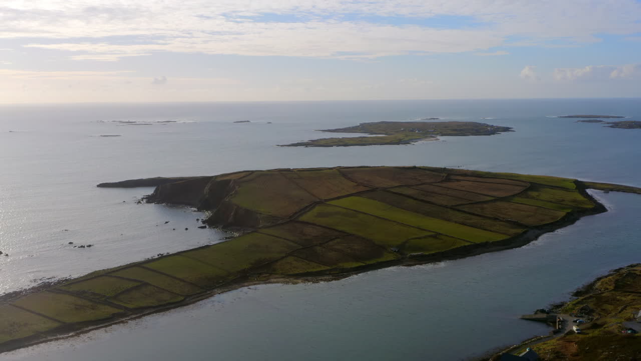 Aerial pullback of Ardmore Island on lower Sky Road, Clifden, revealing scenic farming fields