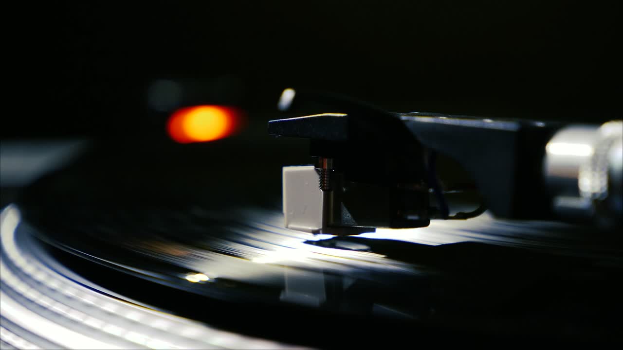 Closeup needle on spinning vintage vinyl record on turntable